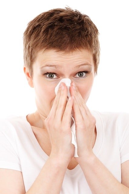 Woman sneezing