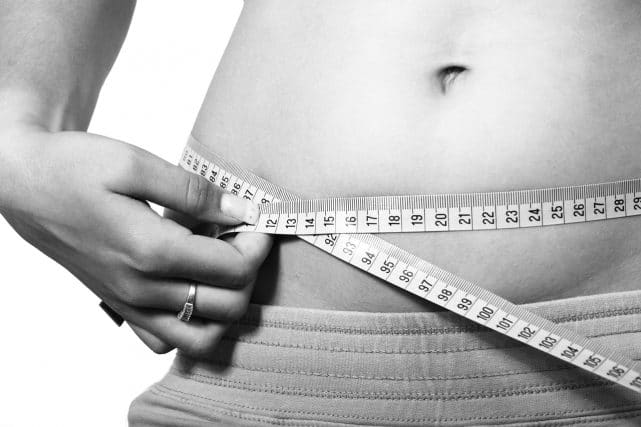 Female stomach with measuring tape