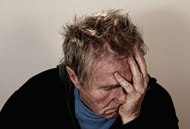 man holding his face in pain