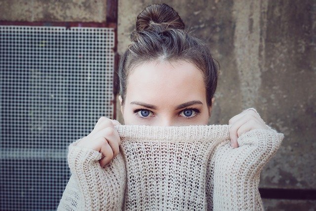 Lady with sweater covering face